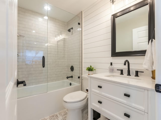 full bathroom with toilet, enclosed tub / shower combo, and vanity