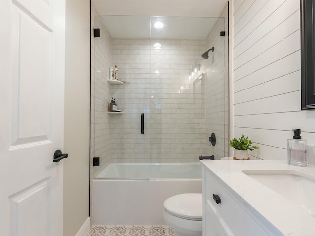 full bath featuring recessed lighting, vanity, bath / shower combo with glass door, tile patterned floors, and toilet