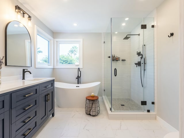 full bathroom with a freestanding bath, a shower stall, vanity, and marble finish floor