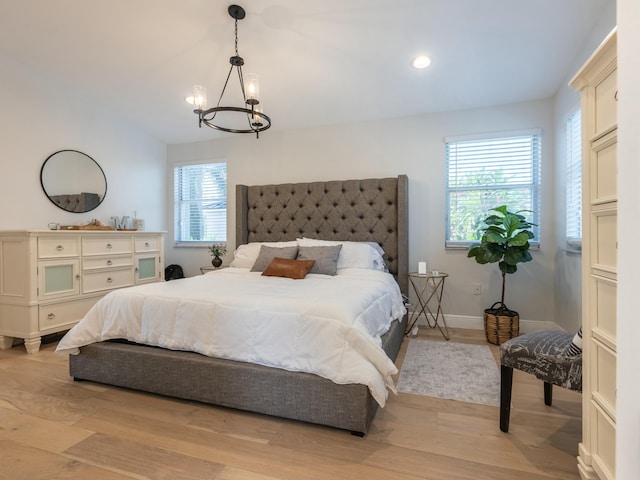 bedroom featuring an inviting chandelier, light wood-style floors, recessed lighting, and baseboards