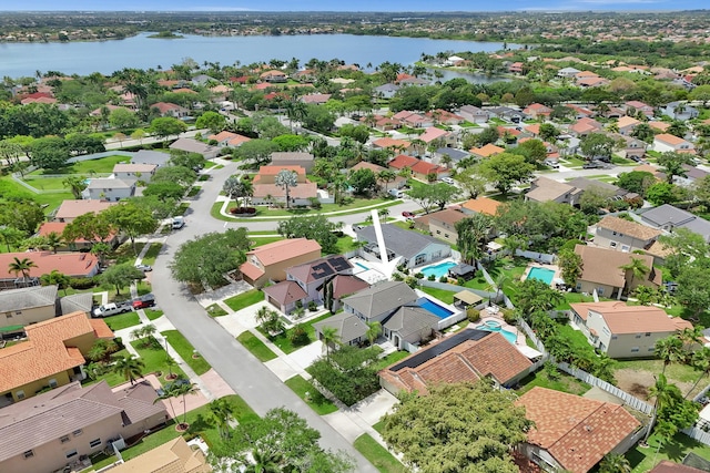 birds eye view of property with a water view and a residential view