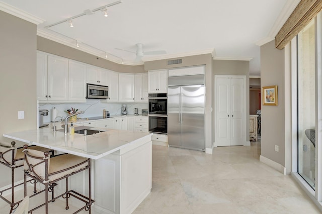 3740 S Ocean Blvd Unit 1602, Highland Beach, FL 33487 - kitchen with visible vents, track lighting, a peninsula, a sink, and appliances with stainless steel finishes