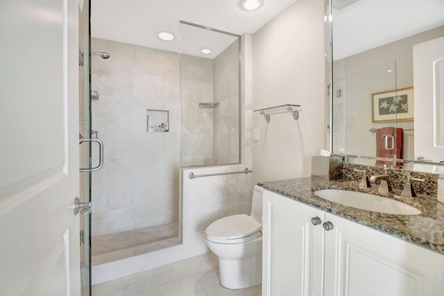 3740 S Ocean Blvd Unit 1602, Highland Beach, FL 33487 - bathroom featuring vanity, a stall shower, and toilet