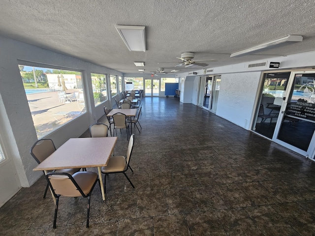 211 Lake Dora Dr, West Palm Beach, FL 33411 - dining room featuring a textured ceiling, a ceiling fan, and stone finish floors