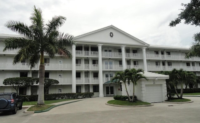 view of property with concrete driveway and an attached garage
