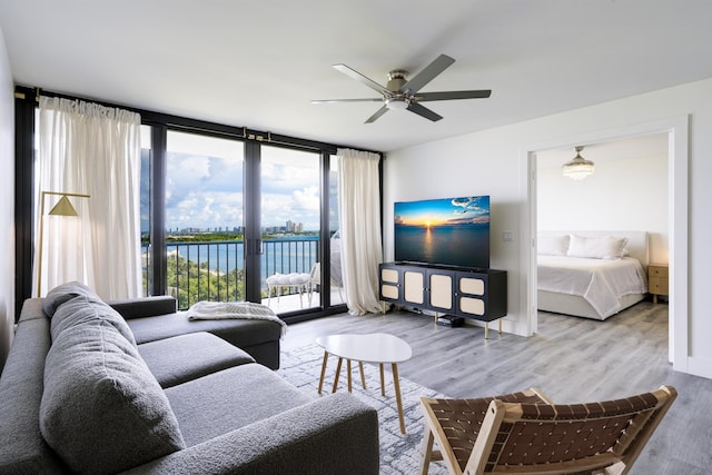 5600 N Flagler Dr Unit 1207, West Palm Beach, FL 33407 - living area with wood finished floors, ceiling fan, and expansive windows