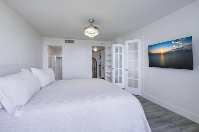 5600 N Flagler Dr Unit 1207, West Palm Beach, FL 33407 - bedroom featuring visible vents, baseboards, french doors, wood finished floors, and a spacious closet