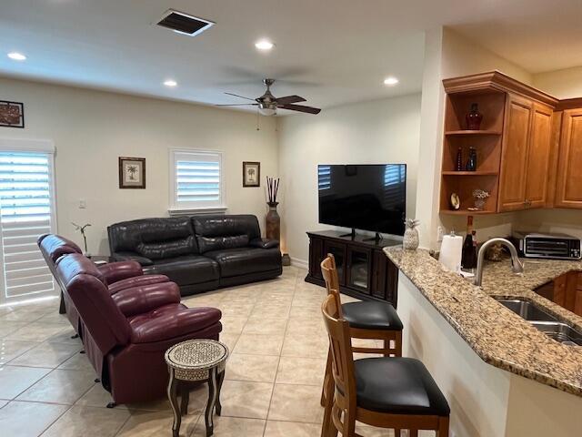 living area with recessed lighting, a toaster, light tile patterned floors, visible vents, and a ceiling fan