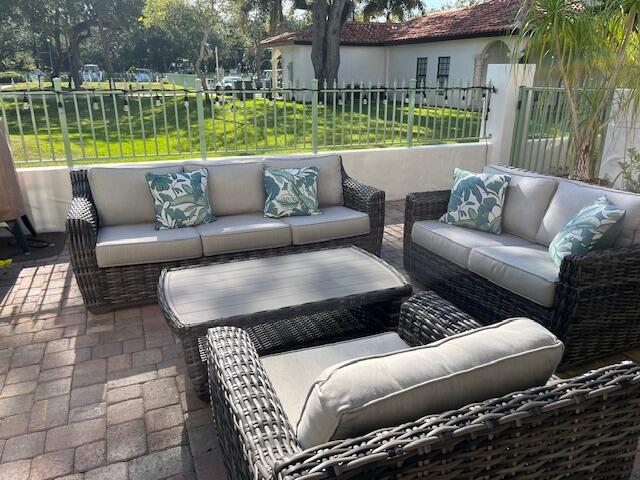 view of patio with an outdoor living space and fence