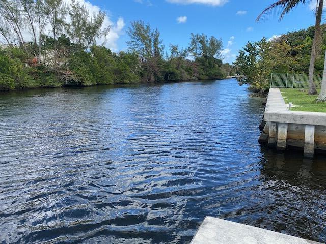 view of dock with fence and a water view