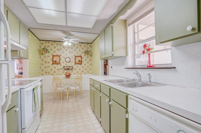 1695 Roy Dr, West Palm Beach, FL 33415 - kitchen featuring a sink, white appliances, green cabinetry, light floors, and wallpapered walls
