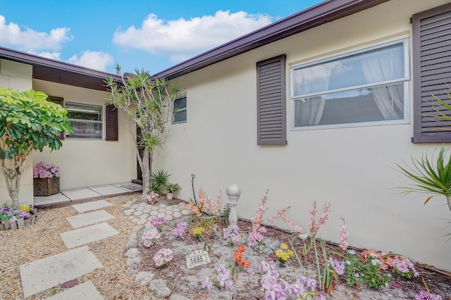 1695 Roy Dr, West Palm Beach, FL 33415 - view of side of property featuring stucco siding