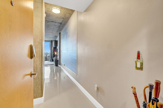 300 S Australian Ave Unit 409, West Palm Beach, FL 33401 - hallway featuring light tile patterned flooring and baseboards