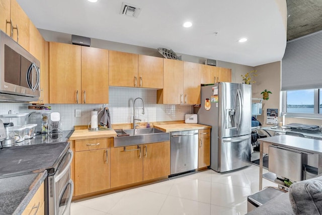 300 S Australian Ave Unit 409, West Palm Beach, FL 33401 - kitchen with decorative backsplash, visible vents, appliances with stainless steel finishes, a sink, and recessed lighting