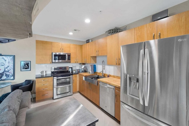 300 S Australian Ave Unit 409, West Palm Beach, FL 33401 - kitchen featuring a sink, stainless steel appliances, recessed lighting, tasteful backsplash, and visible vents