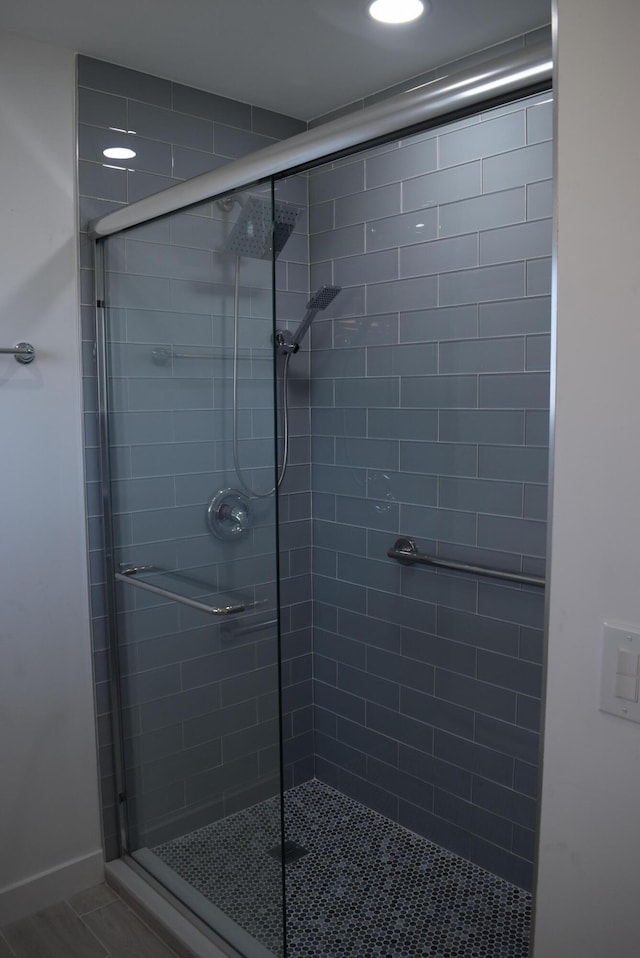 full bathroom with tile patterned floors and a shower stall