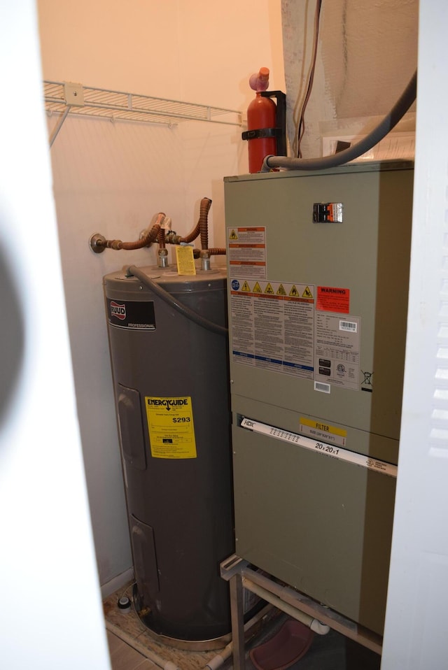 utility room featuring water heater and heating unit