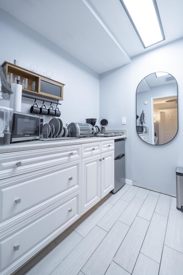 45 Misty Meadow Dr, Boynton Beach, FL 33436 - kitchen with fridge, arched walkways, white cabinets, and light countertops