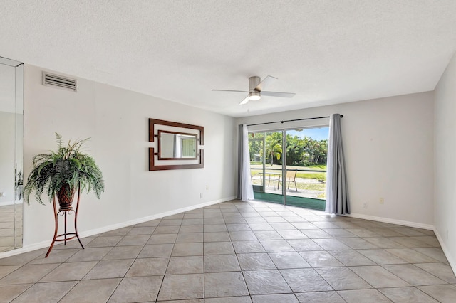 unfurnished room with visible vents, baseboards, ceiling fan, a textured ceiling, and light tile patterned floors