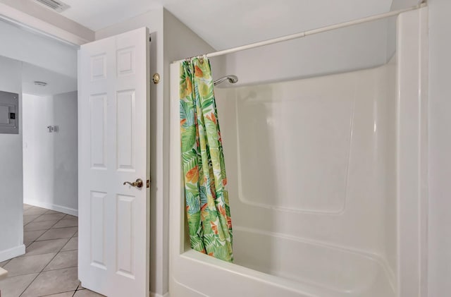 bathroom featuring baseboards, tile patterned flooring, shower / bathtub combination with curtain, and visible vents