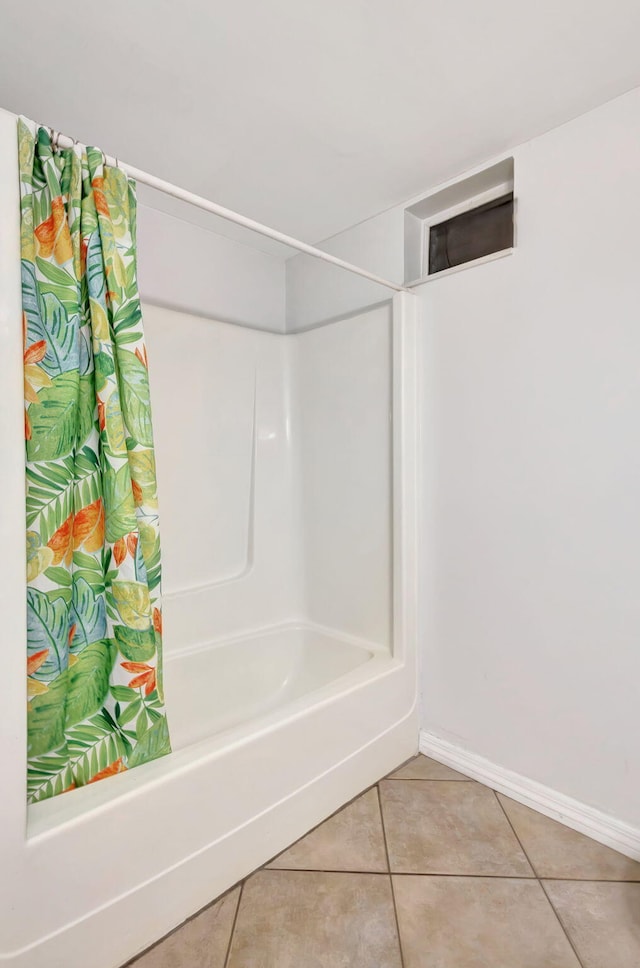 full bathroom with baseboards, tile patterned flooring, and shower / bath combination with curtain