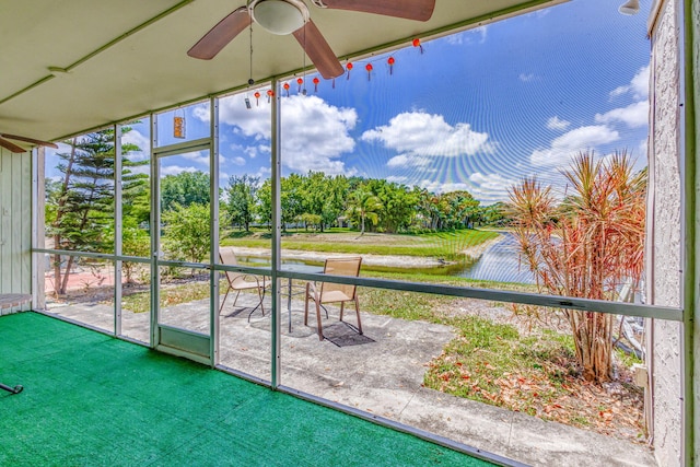 unfurnished sunroom with a ceiling fan