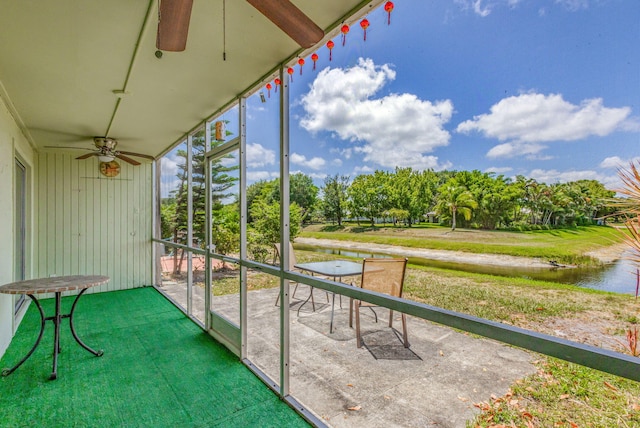 unfurnished sunroom with ceiling fan