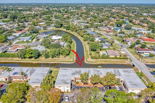 drone / aerial view featuring a water view and a residential view