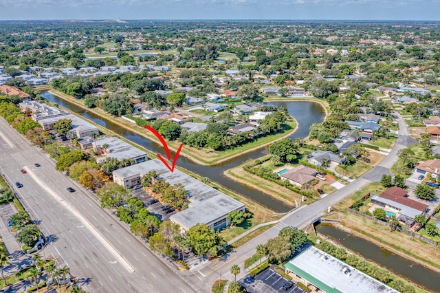 drone / aerial view featuring a water view and a residential view