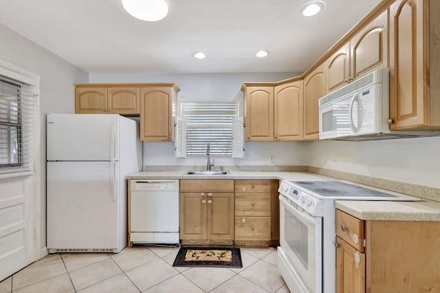 kitchen featuring a sink, light brown cabinets, white appliances, and light countertops