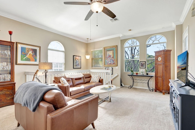 living room featuring a wealth of natural light, visible vents, a ceiling fan, and light colored carpet