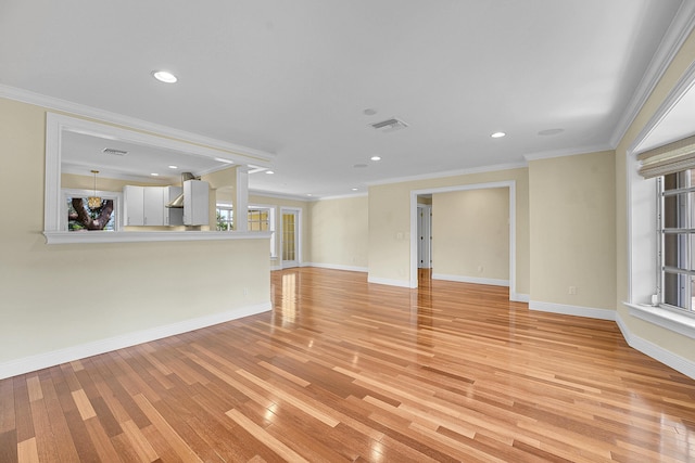 unfurnished living room with visible vents, crown molding, baseboards, recessed lighting, and light wood-style flooring