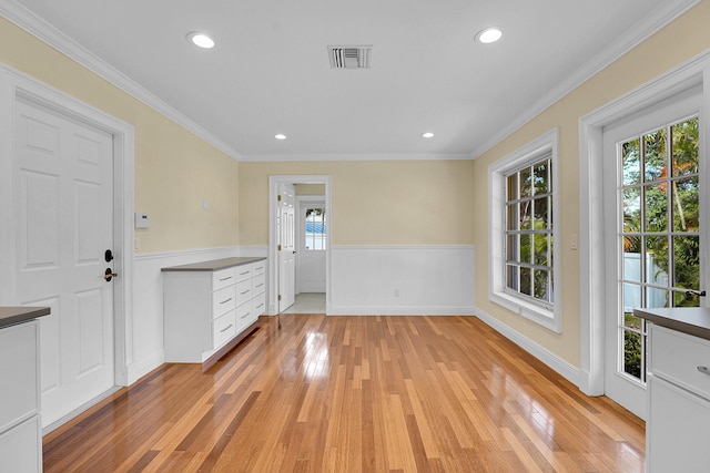 interior space featuring visible vents, recessed lighting, light wood-style flooring, and wainscoting