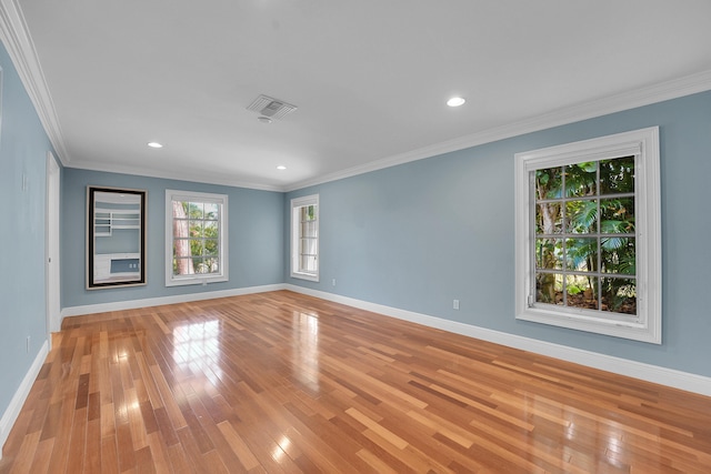 empty room featuring baseboards, visible vents, and light wood-style flooring
