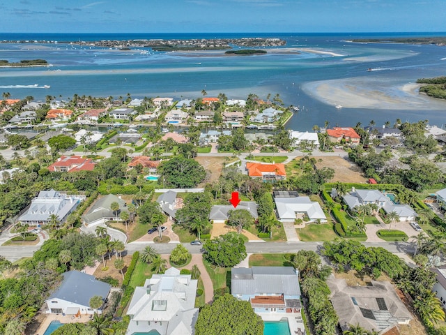 drone / aerial view with a residential view and a water view