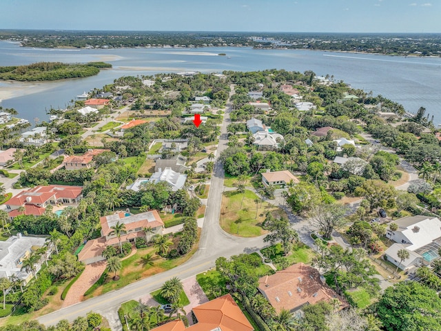 birds eye view of property with a water view and a residential view