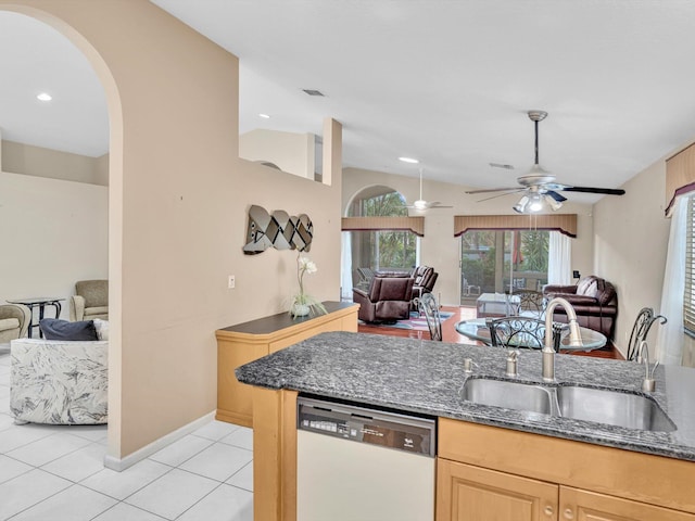 kitchen featuring white dishwasher, light brown cabinetry, a sink, and open floor plan