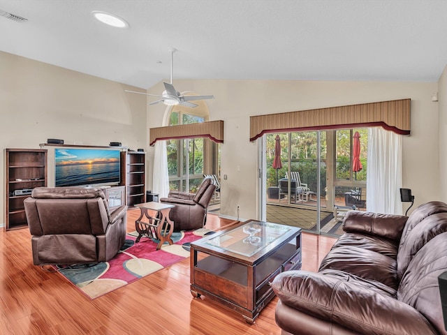 living area featuring ceiling fan, vaulted ceiling, visible vents, and light wood-style floors