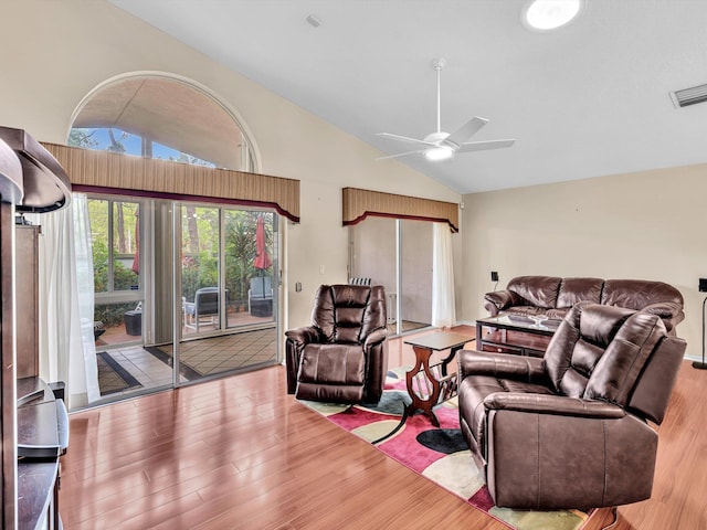 living room featuring ceiling fan, visible vents, wood finished floors, and high vaulted ceiling