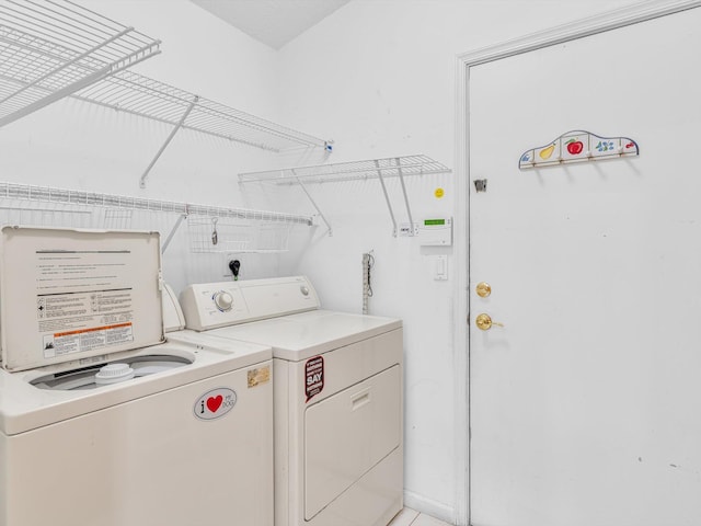 clothes washing area featuring laundry area and washing machine and clothes dryer