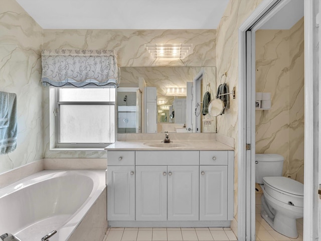 full bathroom with vanity, tile patterned floors, a bath, and toilet