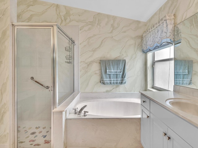 bathroom with vanity, a bath, and a stall shower