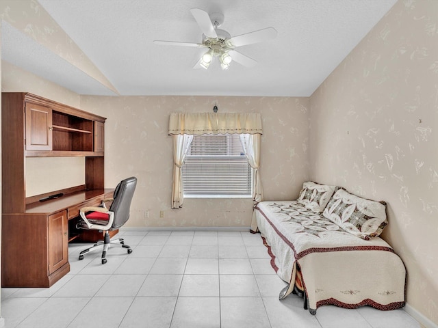office area with baseboards, ceiling fan, and lofted ceiling
