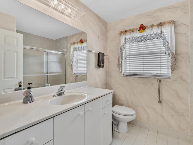 bathroom featuring vanity, tile patterned floors, a stall shower, and toilet