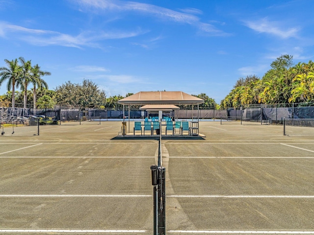 view of tennis court featuring fence