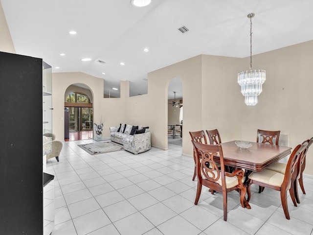 dining room featuring visible vents, arched walkways, light tile patterned floors, ceiling fan with notable chandelier, and lofted ceiling
