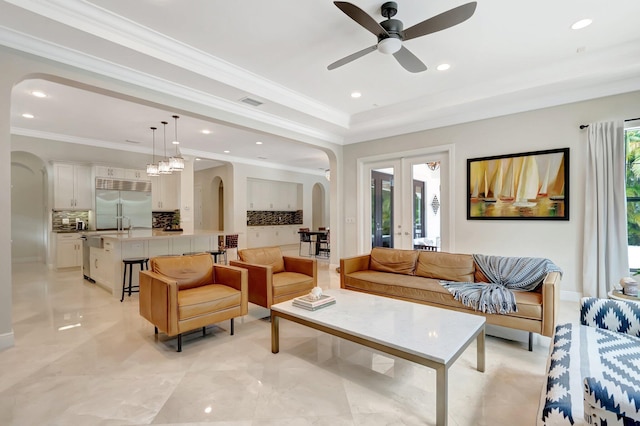 living room with recessed lighting, a ceiling fan, and arched walkways