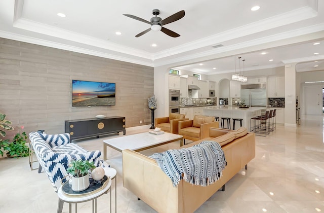 living room featuring recessed lighting, arched walkways, ornamental molding, ceiling fan, and visible vents
