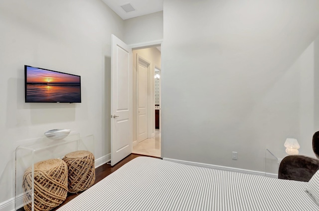 bedroom featuring visible vents, baseboards, and dark wood-type flooring