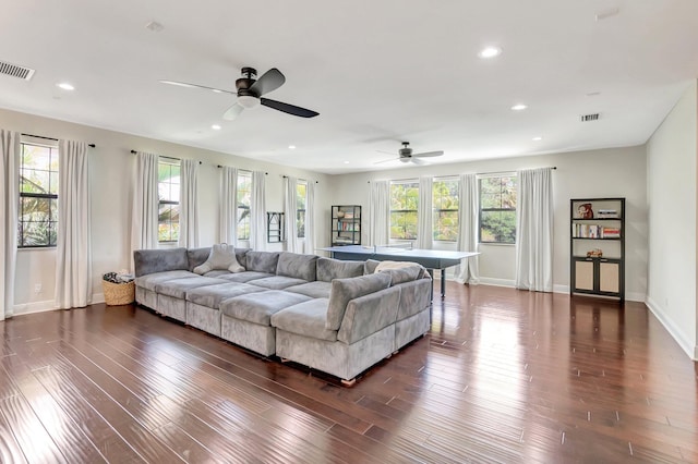 living room with dark wood-type flooring, visible vents, plenty of natural light, and recessed lighting